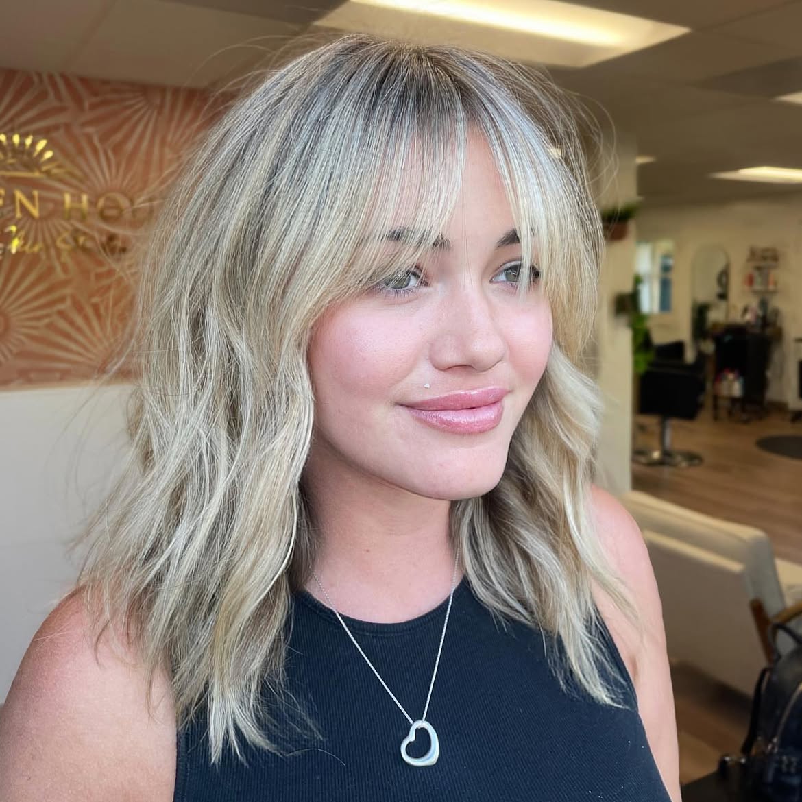 Beachy Blonde Curtain Bangs With Soft Waves