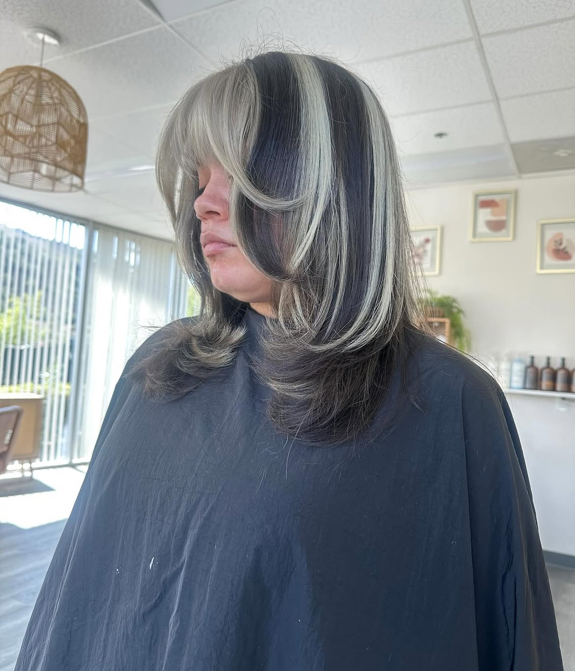 Bold Skunk Stripe Hair With Face Framing Layers