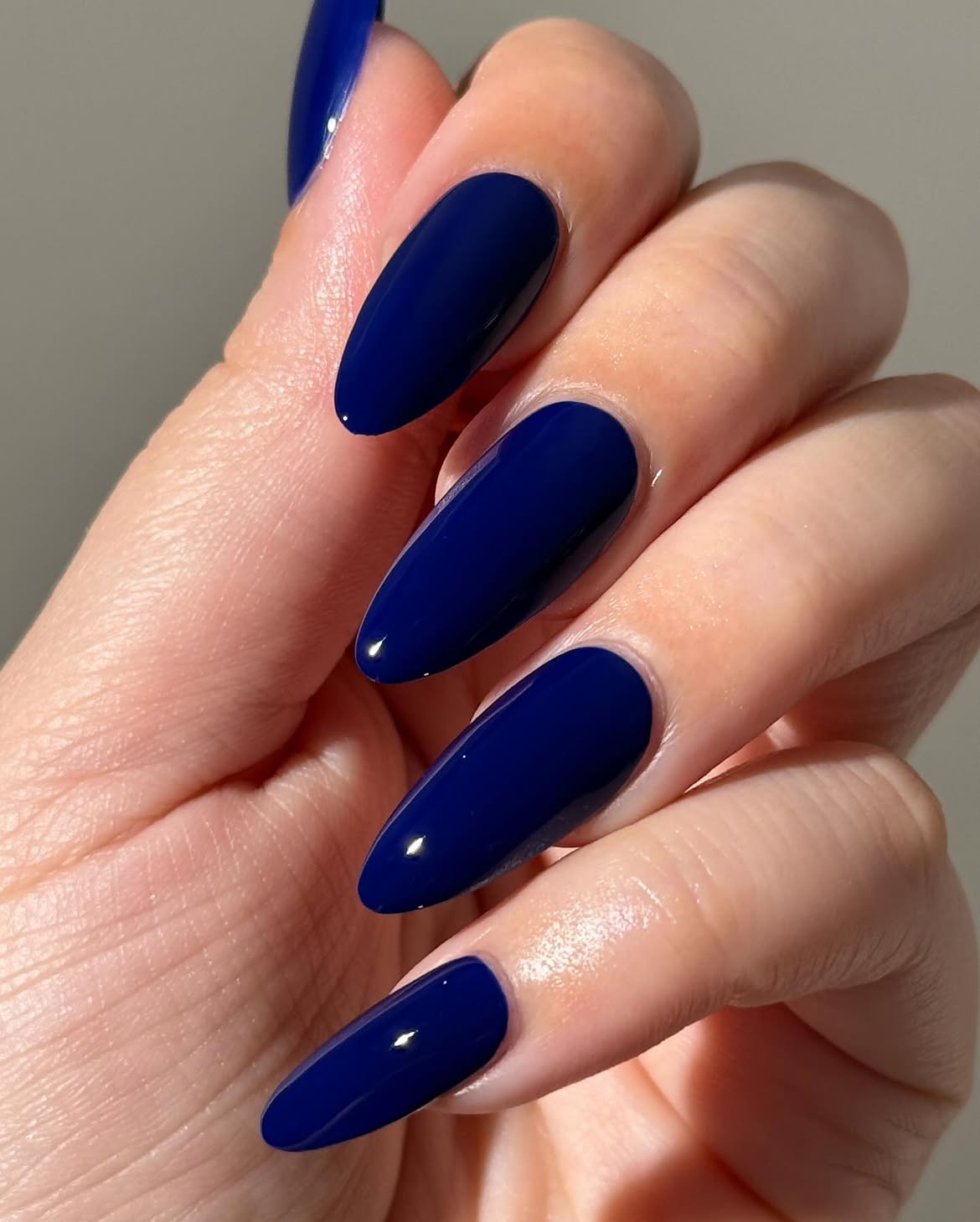 Deep Ocean Blue Glossy Almond Nails