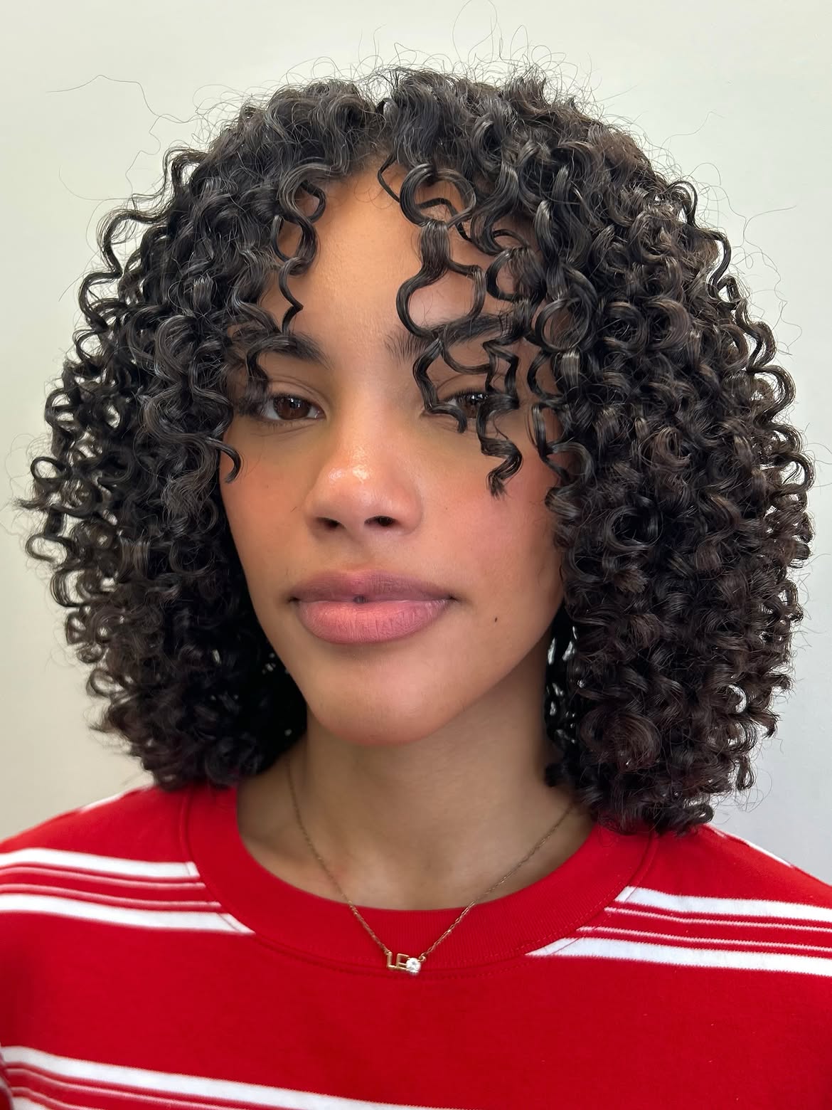 Defined Curly Bob With Natural Face Framing Fringe