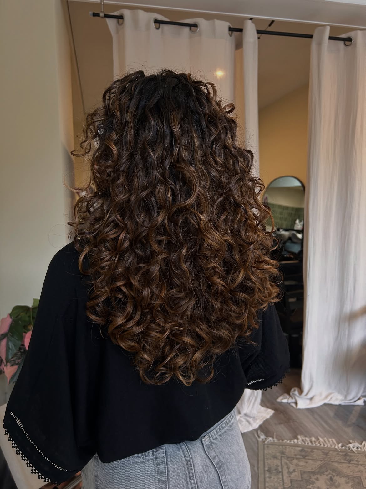 Dimensional Caramel Highlights On Long Curly Layers