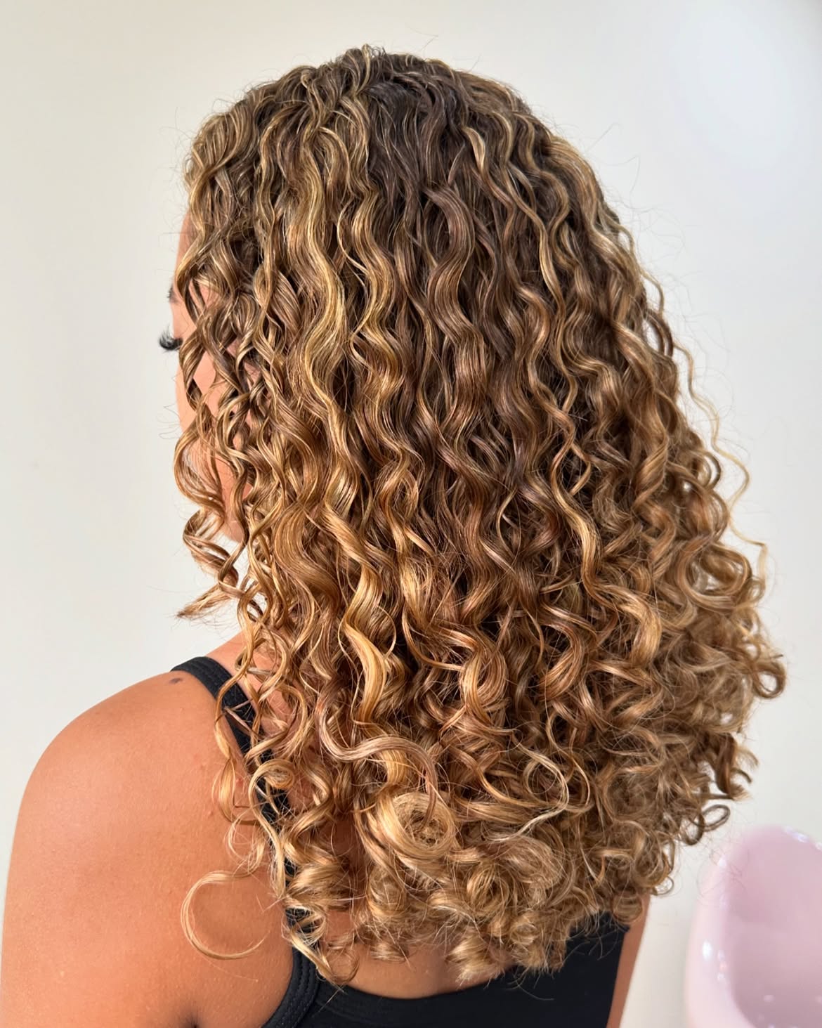 Dimensional Caramel Highlights On Long Curly Layers