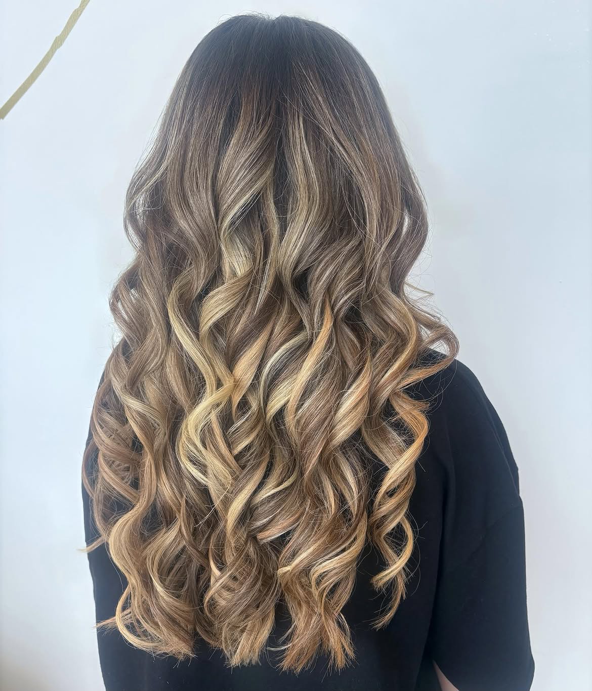 Dimensional Highlights On Long Wavy Brown Hair