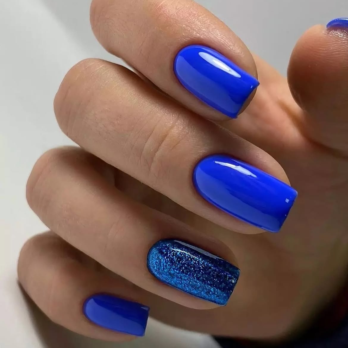Electric Blue Glossy Nails with Glitter Accent
