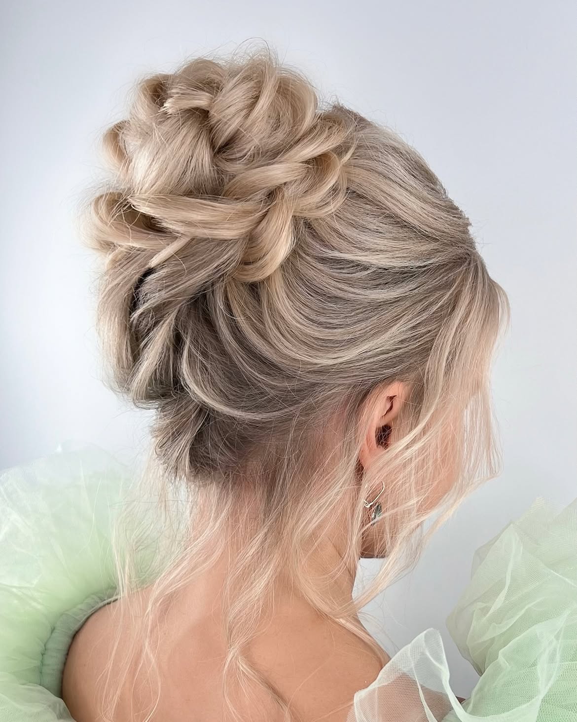 Elegant Braided Updo With Loose Tendrils