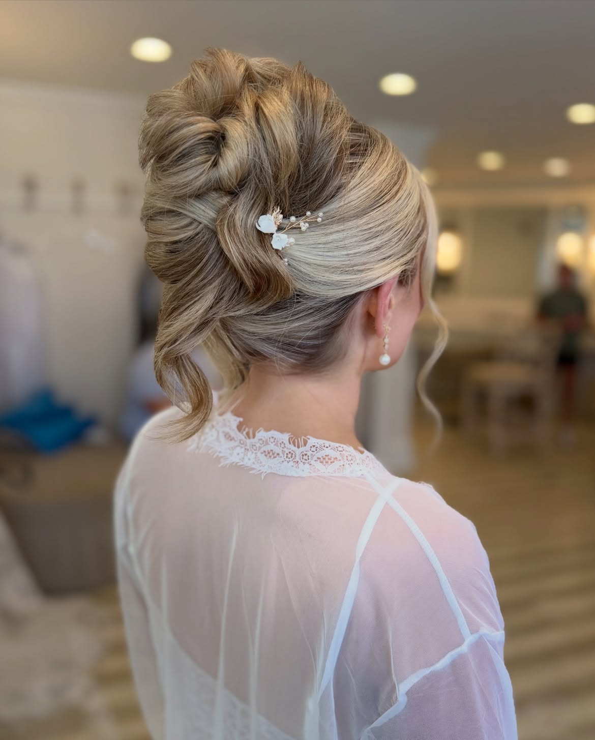 Elegant Chignon Updo With Soft Curls and Pearl Accessories