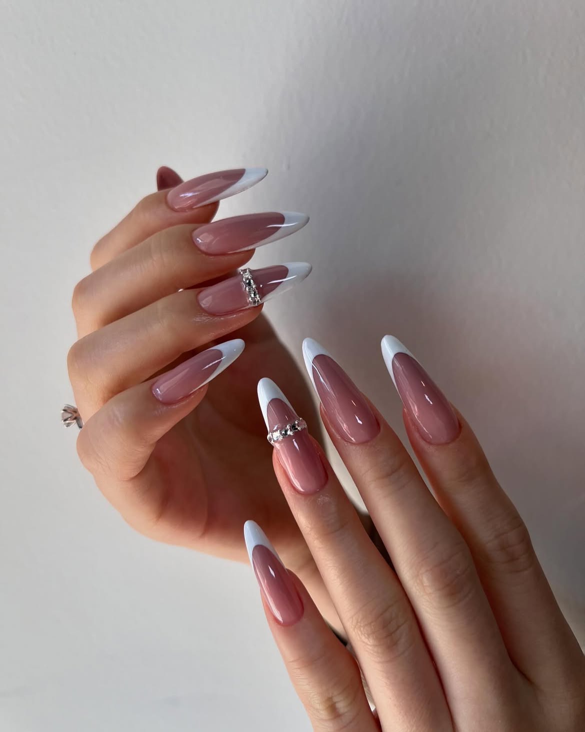 Elegant Milky French Almond Nails with Rhinestone Accents