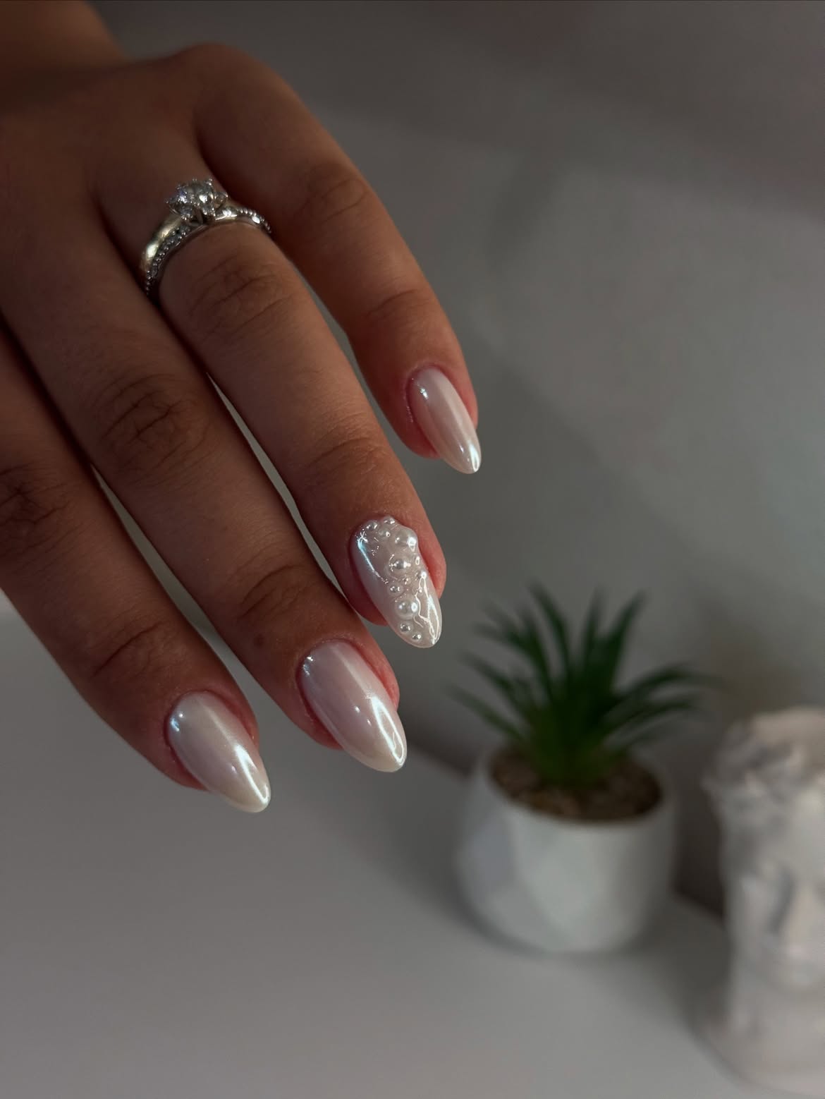 Elegant Pearl Embellished Almond Nails