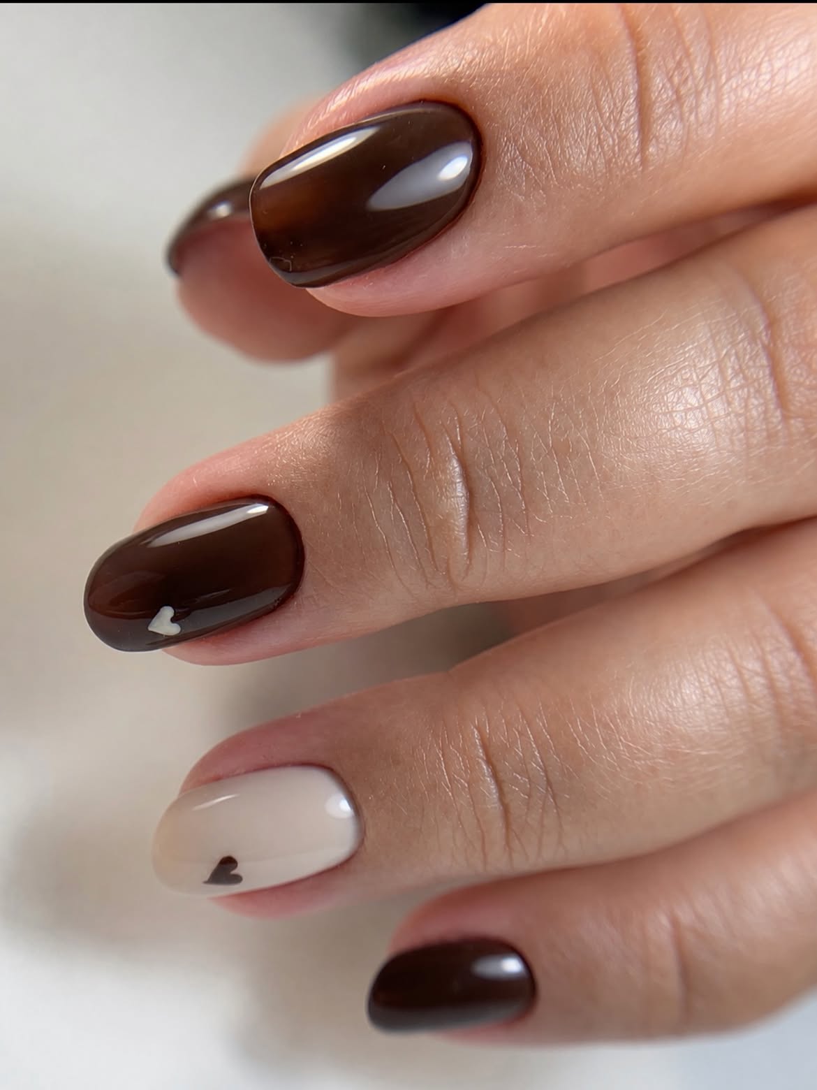 Glossy Chocolate Brown Oval Nails with Creamy Accents