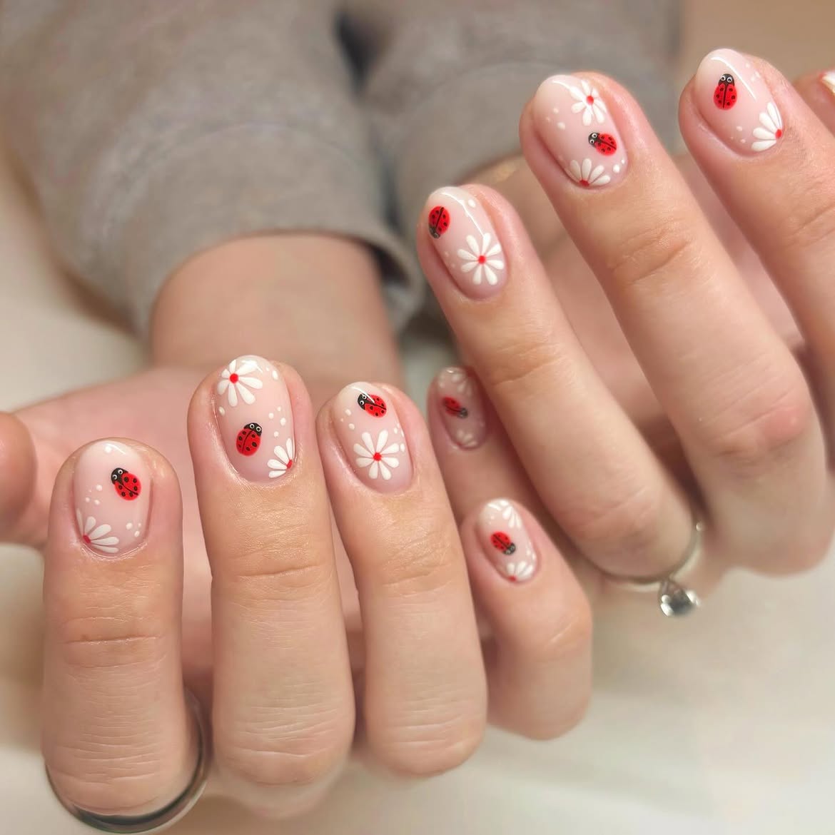 Glossy Nude Nails With Daisy And Ladybug Art