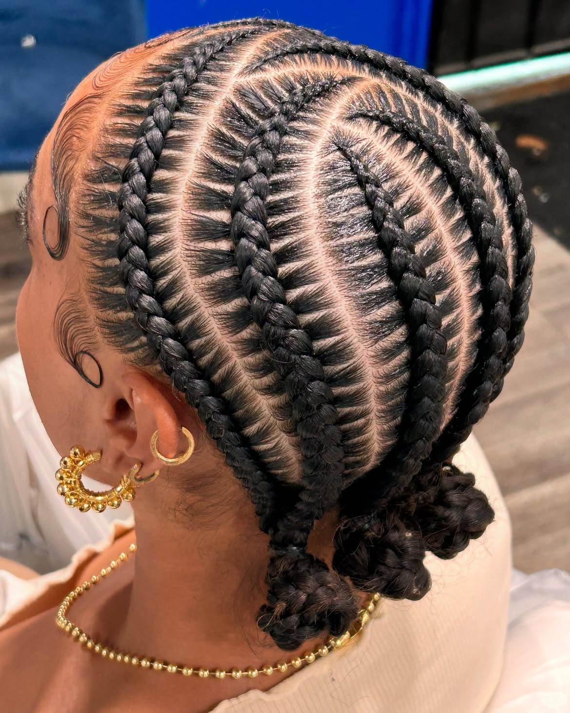 Intricate Geometric Cornrows Into Low Braided Buns