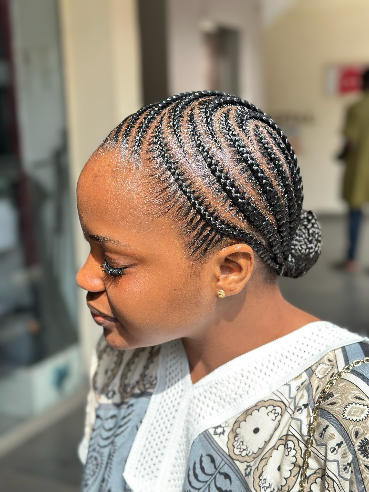 Intricate Swirl Pattern Cornrows With Low Bun