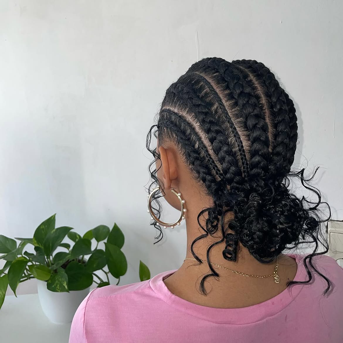 Low Braided Bun With Curly Tendrils