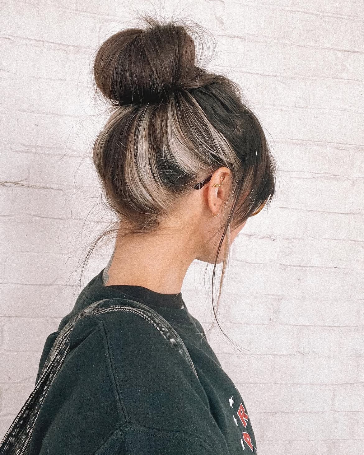 Messy Top Knot With Bold Blonde Streaks