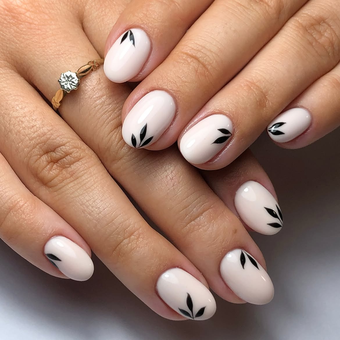 Milky Nude Oval Nails with Black Leaf Accent