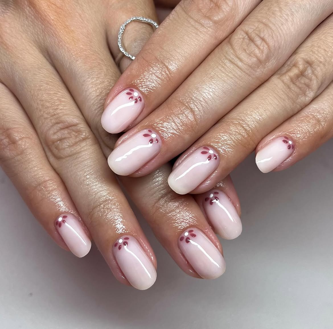 Milky Pink Aura Nails with Burgundy Flower Accents