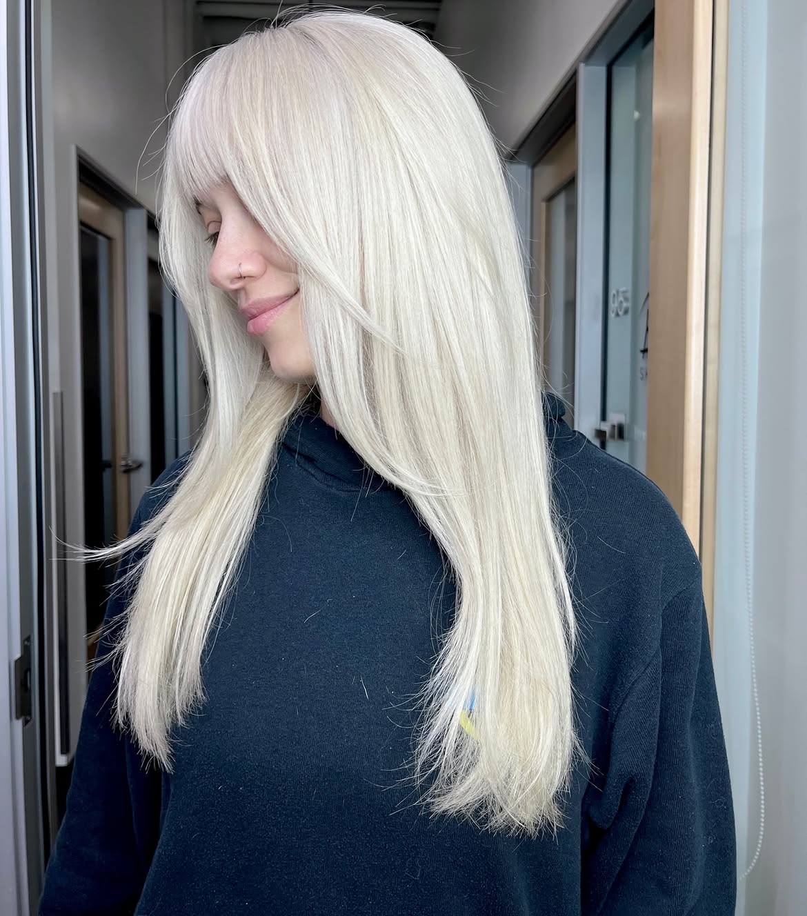 Platinum Blonde with Face-Framing Layers and Bangs