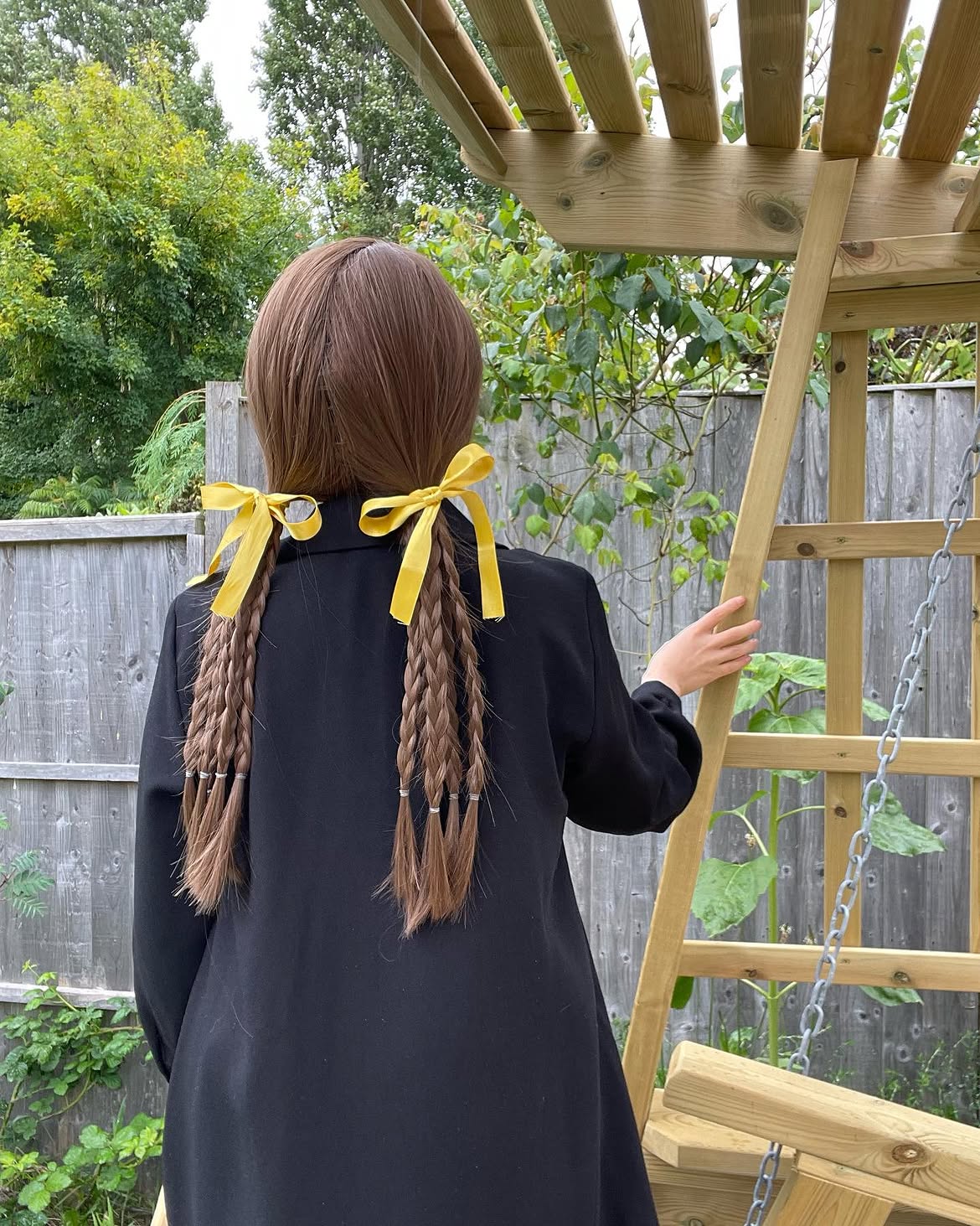 Playful Pigtail Braids With Yellow Ribbon Accents