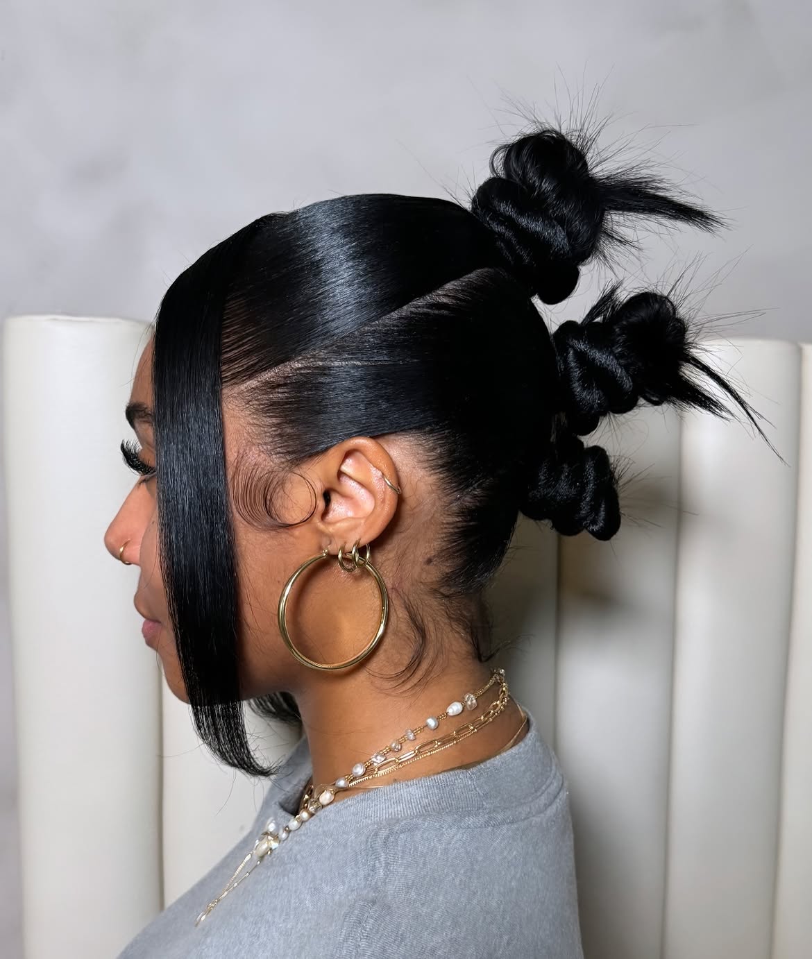 Sleek High Bantu Knots With Wispy Face Framing