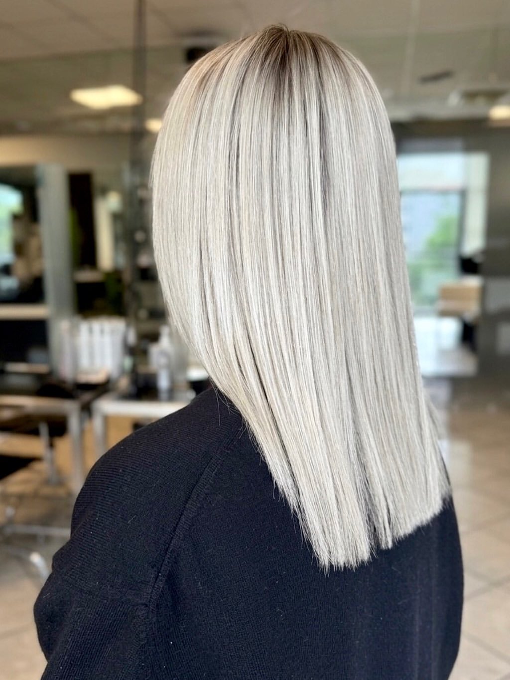 Sleek Platinum Blonde Collarbone Cut With Dark Roots