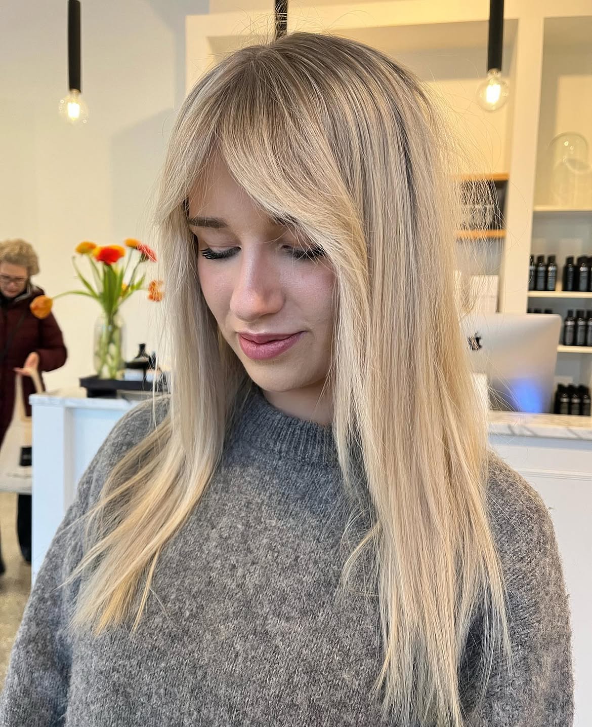 Soft Blonde Balayage With Side Swept Bangs
