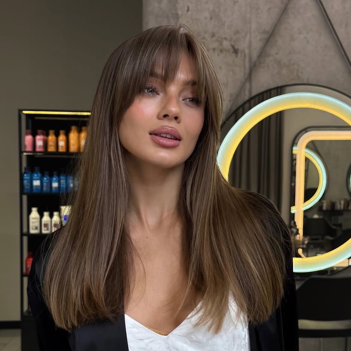 Soft Brown Curtain Bangs With Subtle Highlights