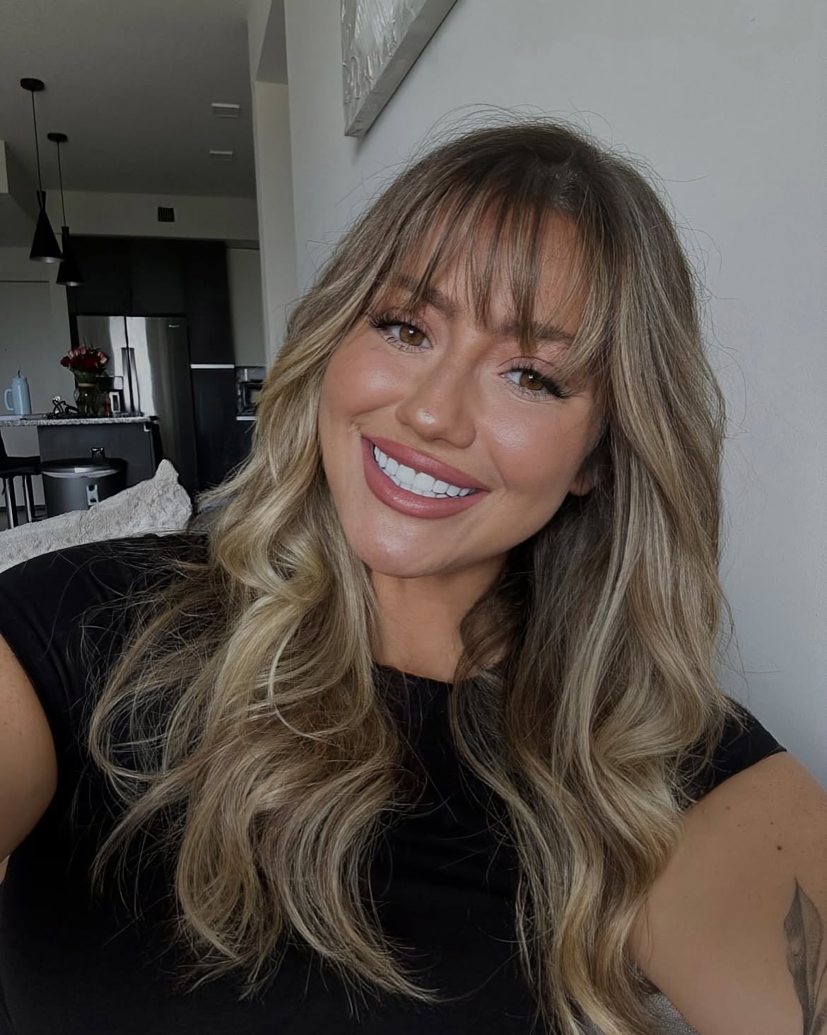 Soft Wispy Bangs With Honey Blonde Balayage Waves