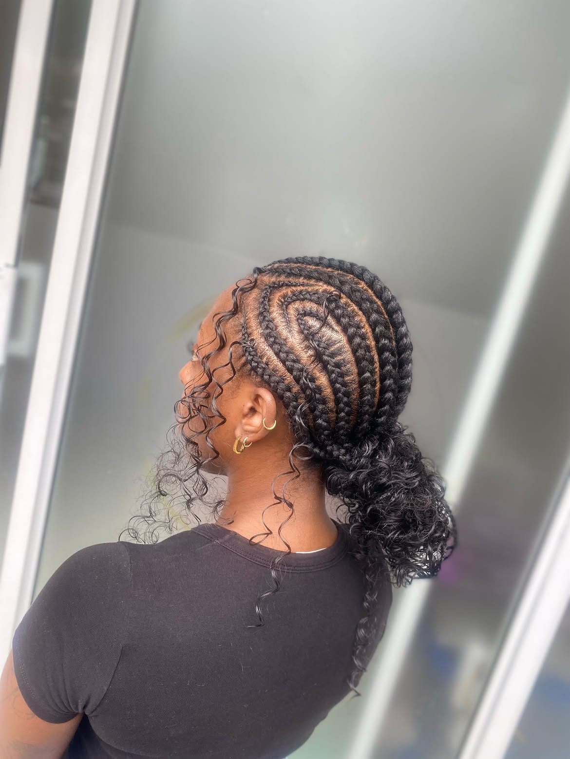 Swirl Feed In Braids With Low Curly Bun
