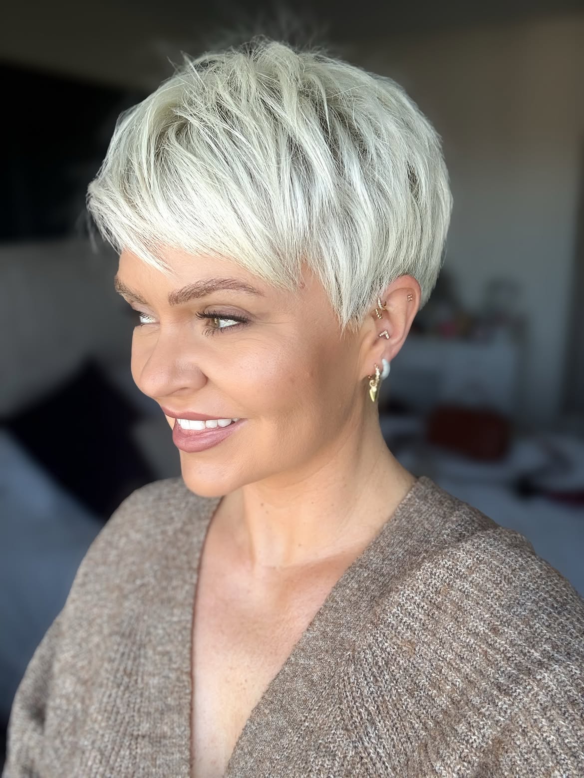 Tousled Platinum Blonde Pixie With Side Swept Bangs