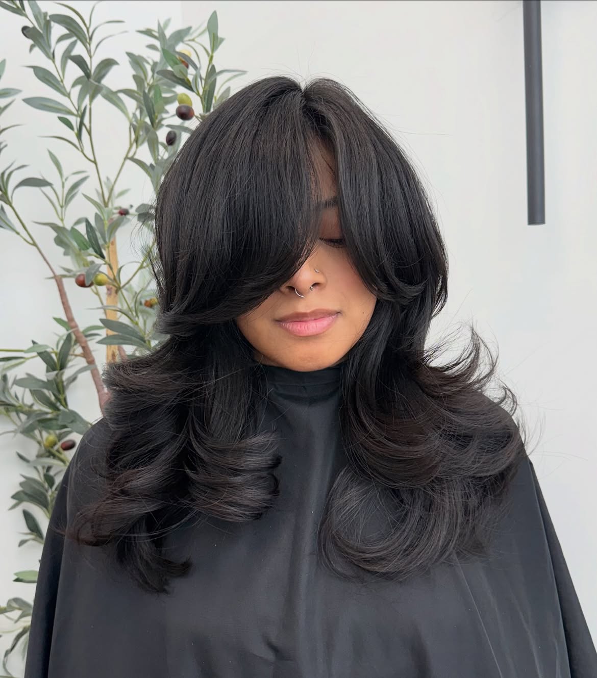 Voluminous Black Layers With Sweep Bangs