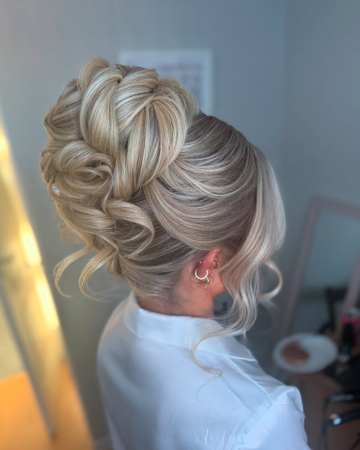 Voluminous Braided Updo With Loose Tendrils
