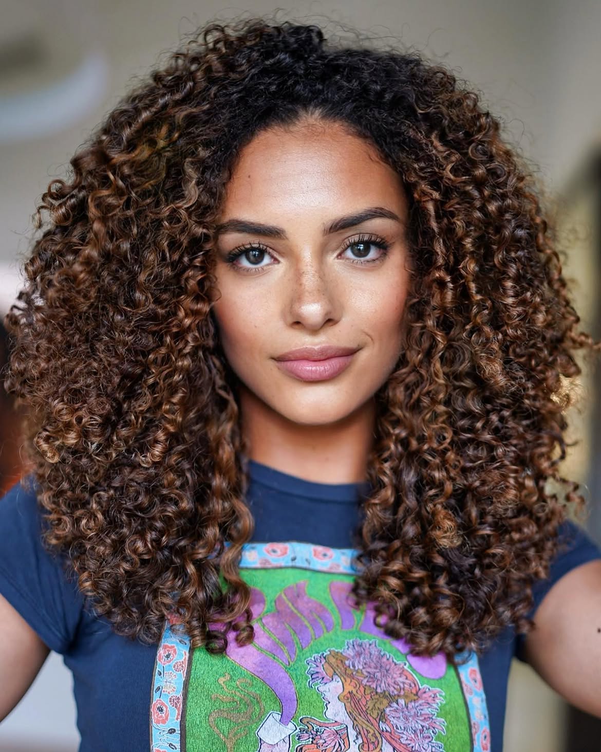 Voluminous Brunette Curls With Warm Caramel Highlights