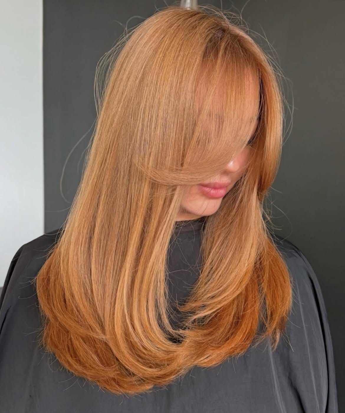 Warm Copper Layers With Face-Framing Bangs