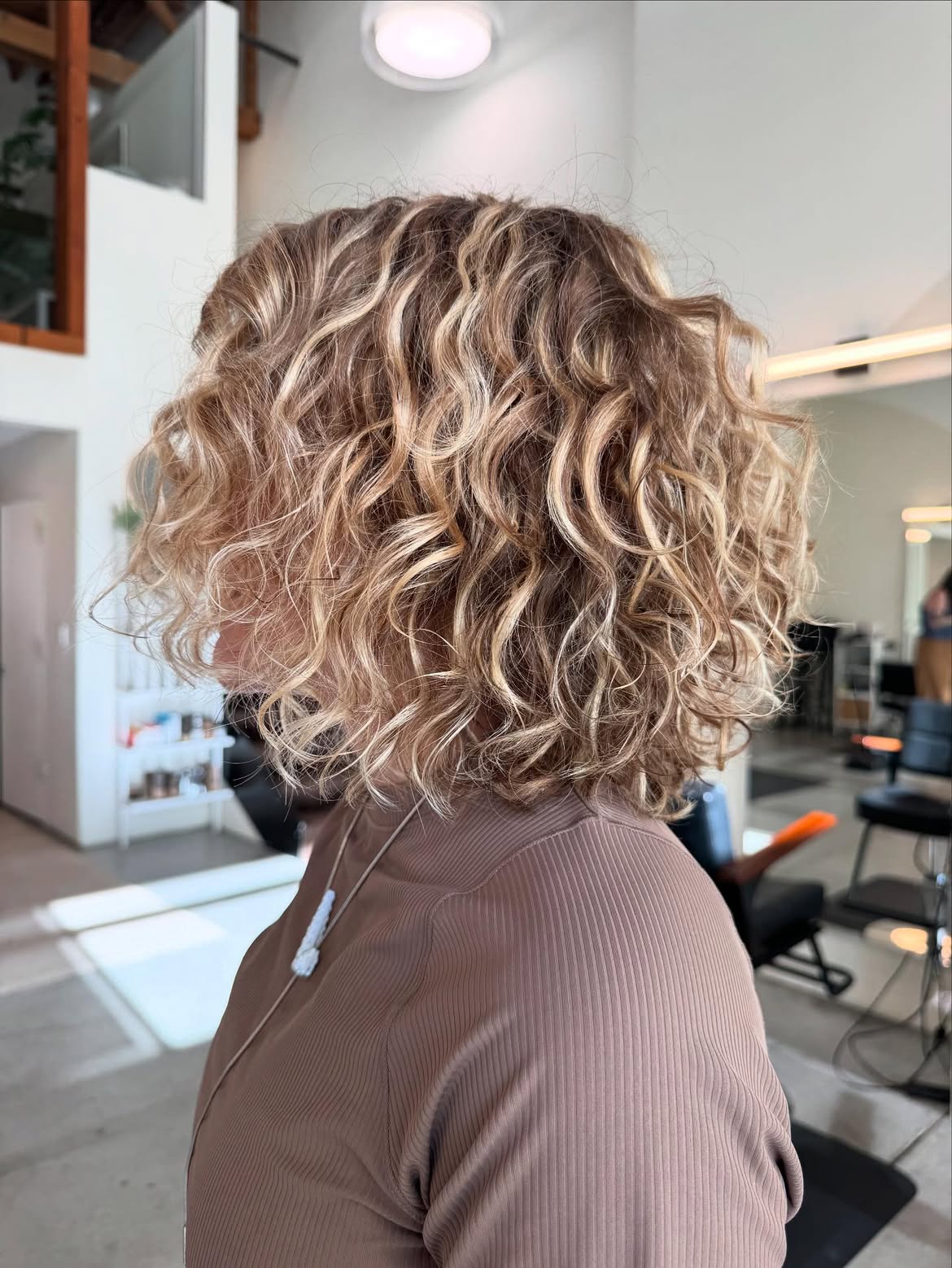 Dimensional Blonde Highlights On A Curly Layered Bob