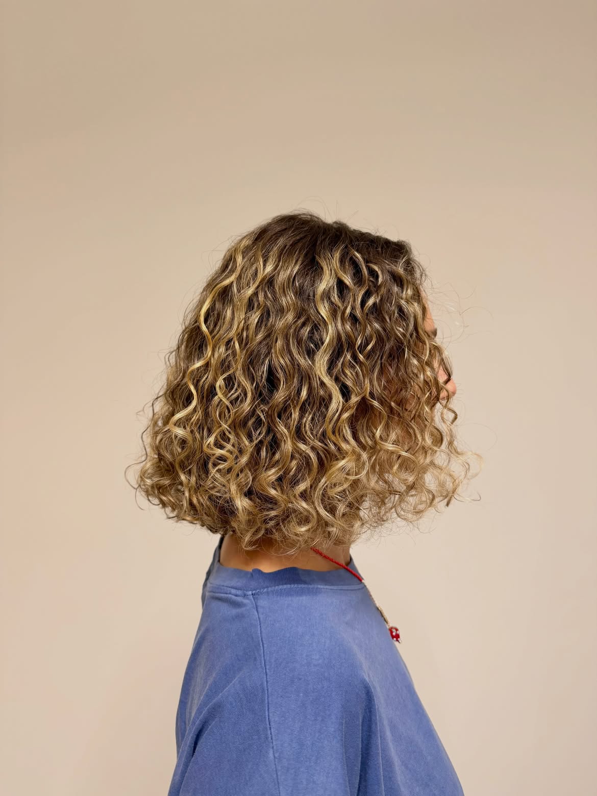 Dimensional Blonde Highlights On Textured Curly Bob