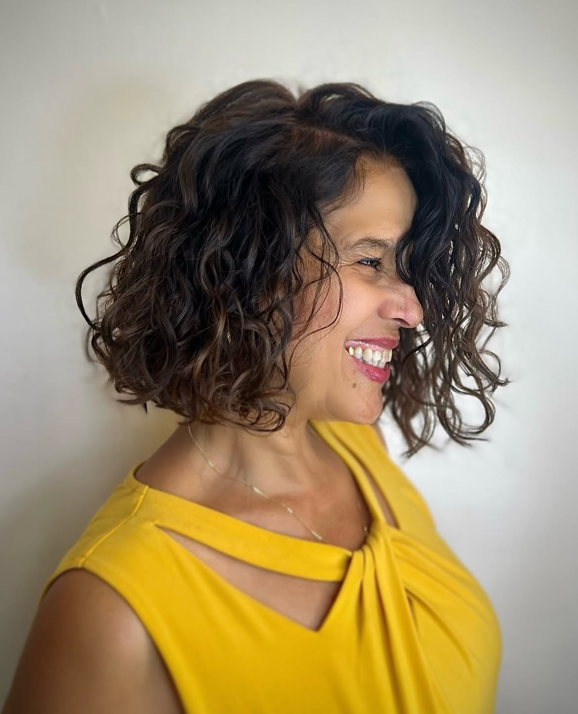 Dimensional Brunette Curly Bob With Deep Side Part
