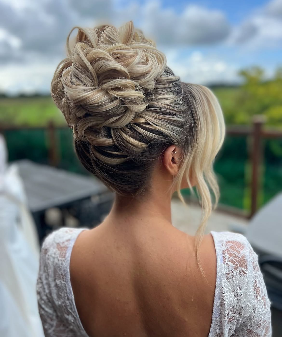 Intricate Textured High Updo With Face Framing Tendrils