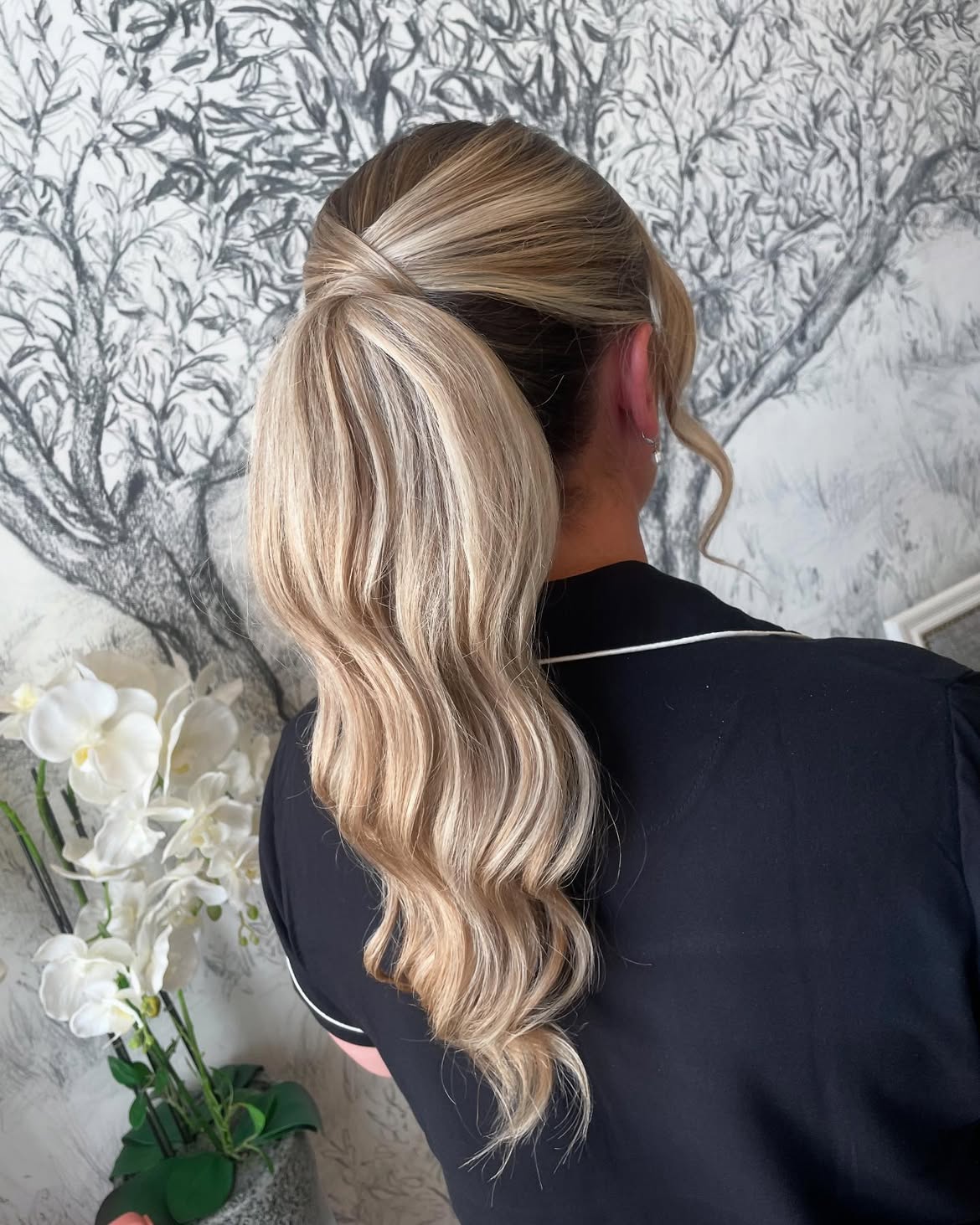 Polished Low Ponytail With Soft Face Framing Waves