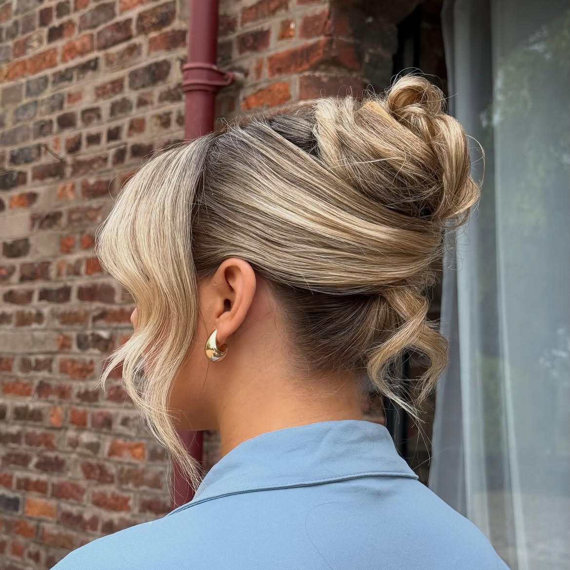 Textured High Bun With Face Framing Layers
