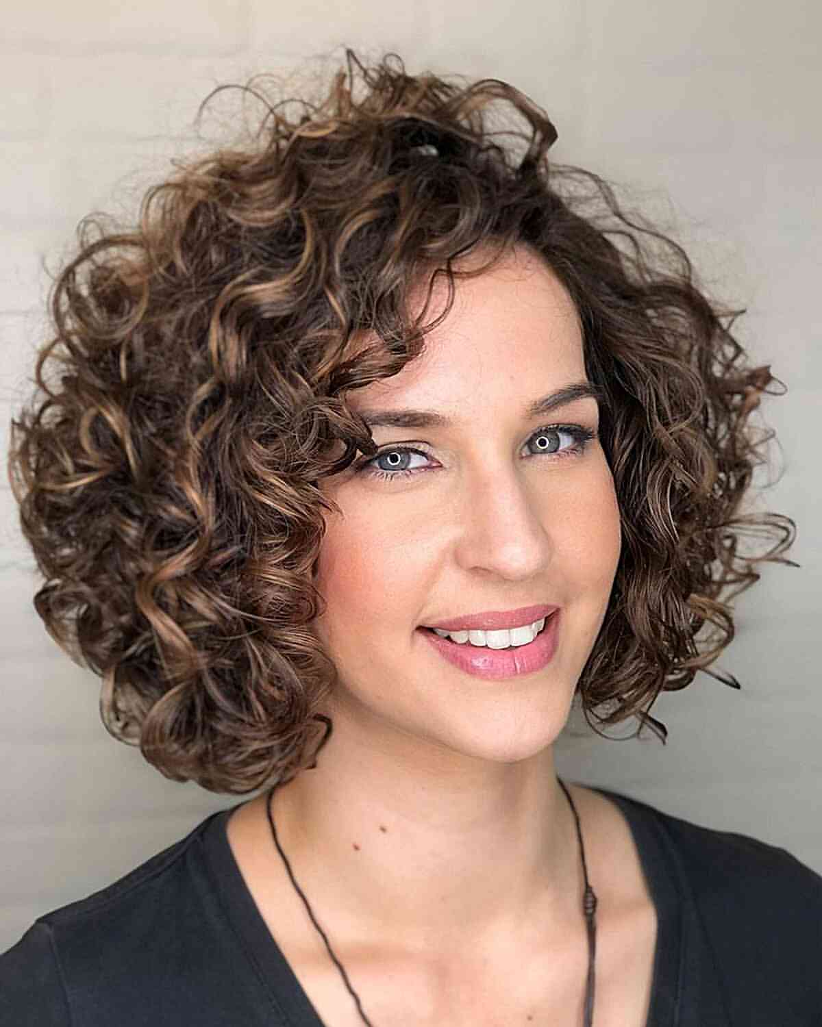 Voluminous Layered Curly Bob With Caramel Highlights